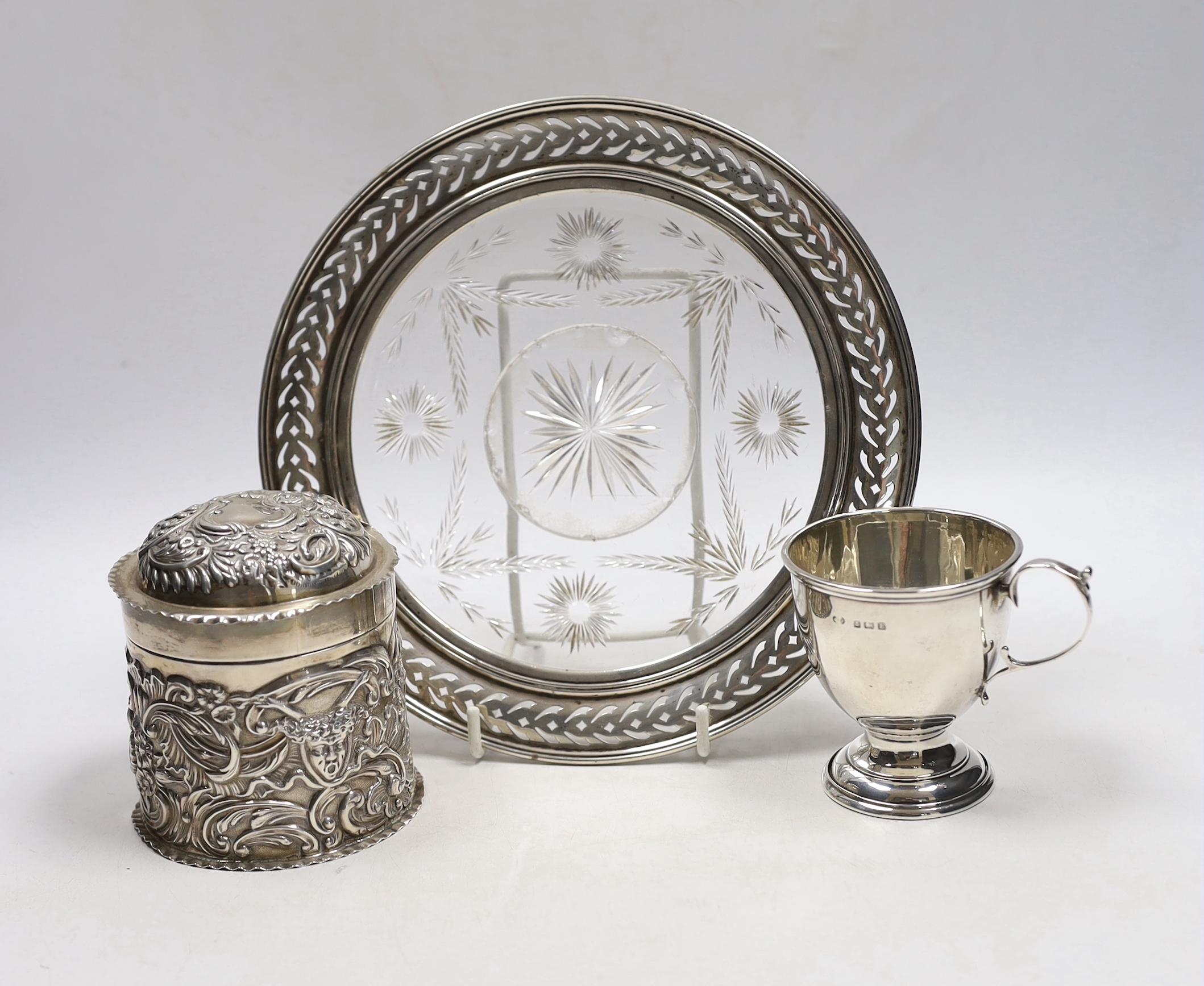 A late Victorian repousse silver cannister and cover, by William Comyns, London, 1896, 92mm a sterling mounted glass stand and a small silver cup.